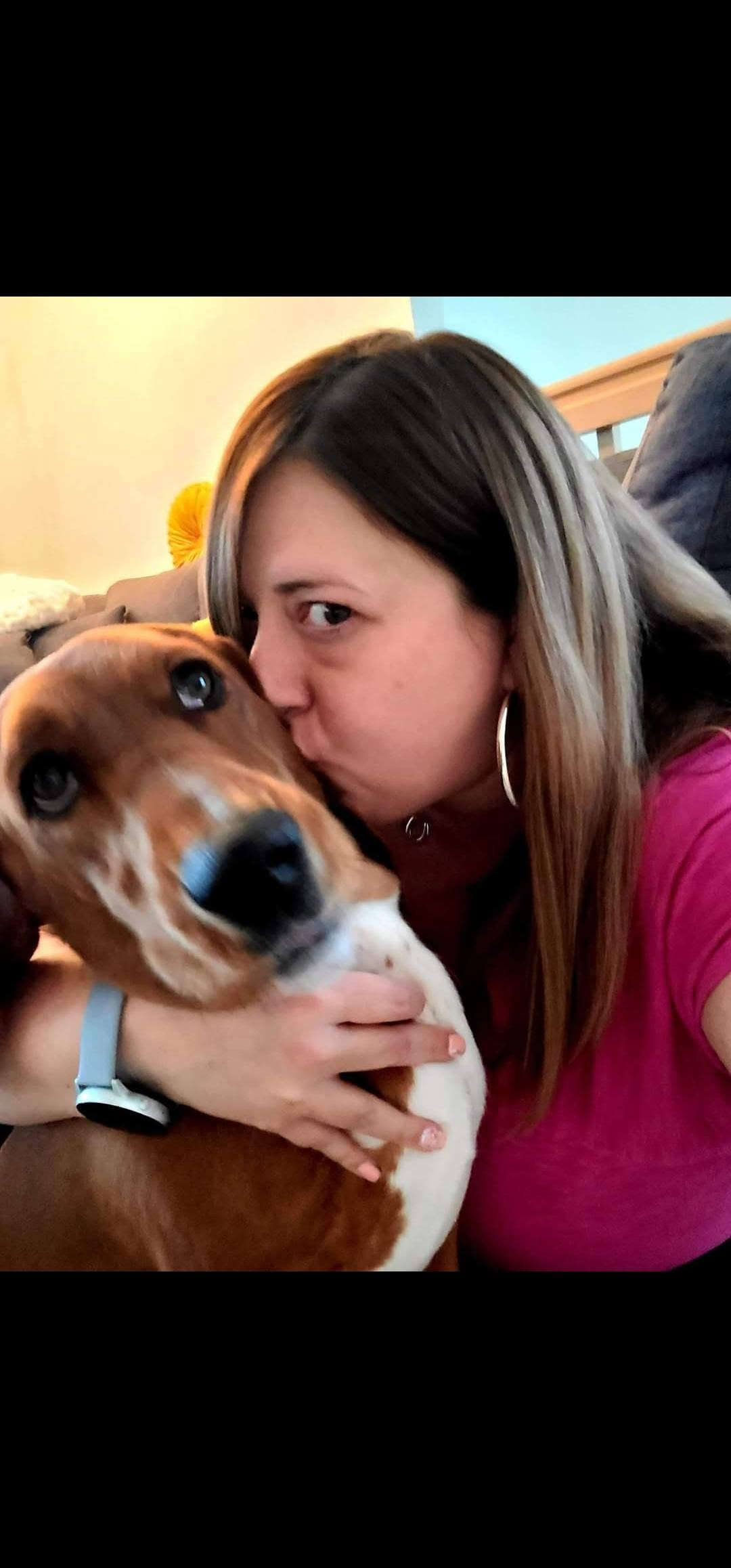 Julie getting a kiss from a basset hound